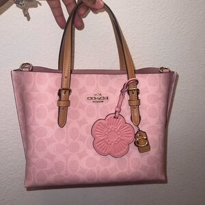 Powder Pink Coach in signature bag with flower charm. Mollie 25 with strap